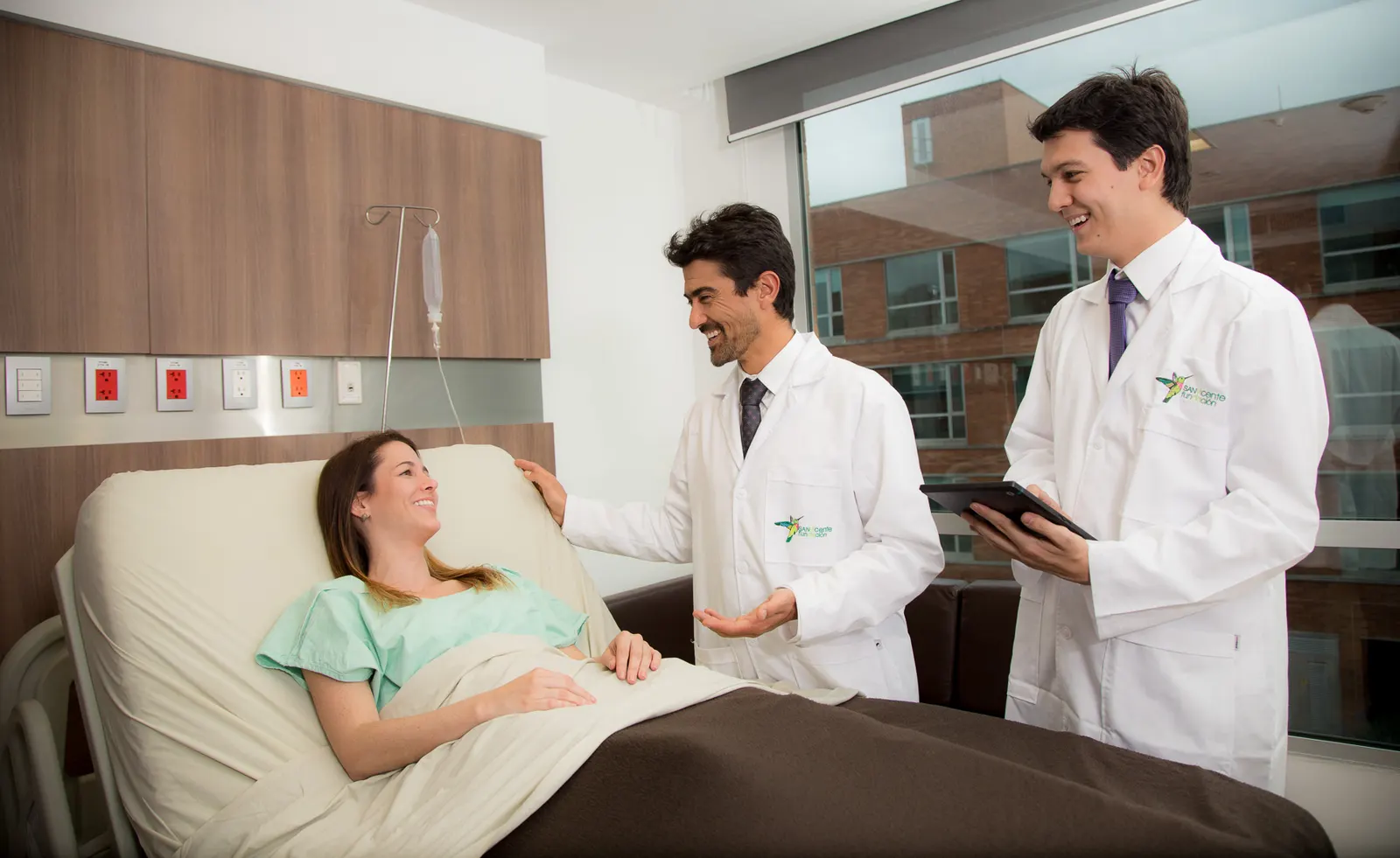 Physicians visiting a patient at her bedside